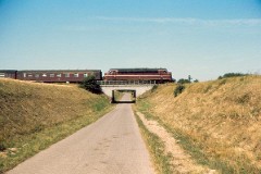 DSBMY class photographed at Bredstrup outside Fredericia - heading for Fredericia. August 1975.   The MY class was built by Nydquist & Holm AB (NOHAB) in Sweden licensed by General Motors. Danish subsuppliers (Frichs and Thrige) took part in the production. A1A-A1A. Dieselelestric. MY 1101 - 1105 was supplied with a General Motor 16-cyl. diesel engine performing 1.700 hp. The diesel engine in MY 1106 - 1144 was performing 1.950 hp - MY 1145 - 1159 1700 hp. Max speed 133 km/h - 83 mph. Length 18 900 mm. Weight 101,6 metric tonnes.